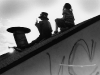 Lyon (Wes Charles, Jr.) & Curtis (Partap Khalsa) huddle on the rooftop